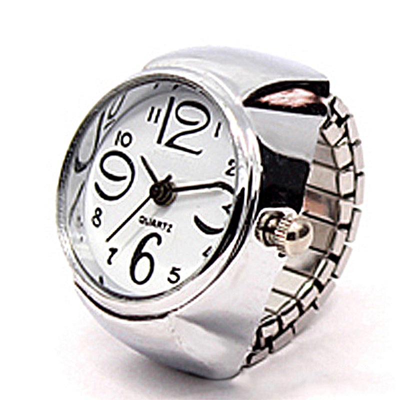 Anillo reloj plateado con forma de flor y números grandes, elegante y único, ideal para estudiantes.